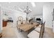 Elegant dining room featuring a modern chandelier, stylish table setting, and seamless flow to adjacent living spaces at 2818 Se 24Th Ave, Ocala, FL 34471