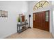 Inviting entryway with beautiful wood door, transom window, and decorative console table, creating a warm welcome at 2818 Se 24Th Ave, Ocala, FL 34471