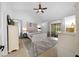 Bright main bedroom with vaulted ceilings, neutral decor, a ceiling fan and sliding glass doors to the patio at 2818 Se 24Th Ave, Ocala, FL 34471