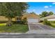 House exterior with a two-car garage and lush landscaping at 9823 Sw 95Th Loop, Ocala, FL 34481