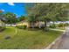 One-story house with a large tree and manicured lawn at 9823 Sw 95Th Loop, Ocala, FL 34481