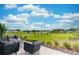 Beautiful brick patio with outdoor seating overlooks a lush green space on a bright, sunny day at 9994 Sw 96Th St, Ocala, FL 34481
