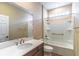 Well-lit bathroom features a shower-tub combo, large mirror, and modern vanity at 9994 Sw 96Th St, Ocala, FL 34481