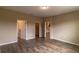 Bedroom with wood floors and multiple doorways at 9994 Sw 96Th St, Ocala, FL 34481