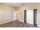 Bedroom showcasing wood-look floors, open closet, and a neutral color scheme at 9994 Sw 96Th St, Ocala, FL 34481