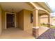 Inviting front porch with stone accents, a decorative front door, and covered entryway at 9994 Sw 96Th St, Ocala, FL 34481