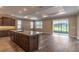 Spacious kitchen featuring stainless appliances, a large island, and seamless access to the outdoor area at 9994 Sw 96Th St, Ocala, FL 34481