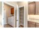 Bright laundry area includes a pantry and granite countertops at 9994 Sw 96Th St, Ocala, FL 34481