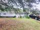 Gray house with a well-maintained lawn and a driveway at 1147 Northcrest Dr, Apopka, FL 32703