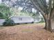 Single story home with a large tree in front at 1147 Northcrest Dr, Apopka, FL 32703