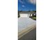 Newly paved driveway leading to a two-car garage, complemented by manicured landscaping at 17536 Se 121St Cir, Summerfield, FL 34491