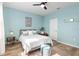 Light blue bedroom with a queen bed and ceiling fan at 9459 Sw 52Nd Loop, Ocala, FL 34481