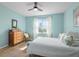 Serene bedroom with light blue walls, a comfortable bed, and hardwood floors at 9459 Sw 52Nd Loop, Ocala, FL 34481