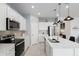 Spacious kitchen featuring an island, stainless steel appliances, and white cabinetry at 9459 Sw 52Nd Loop, Ocala, FL 34481