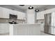 White kitchen island with sink and stainless steel appliances at 9459 Sw 52Nd Loop, Ocala, FL 34481