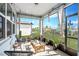 Relaxing screened porch with seating and plants at 9459 Sw 52Nd Loop, Ocala, FL 34481