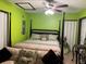 Green walls, king bed, and sitting area in bedroom at 147 Juniper Run, Ocala, FL 34480