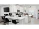 Bright kitchen features white cabinetry, stainless steel appliances, quartz counters and a breakfast bar at 7531 Sw 77Th Ave, Ocala, FL 34481