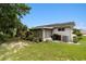 View of the backyard with a screened lanai, well-kept lawn, and lush plantings for a peaceful retreat at 10978 Sw 83Rd Ave, Ocala, FL 34481
