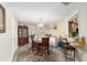 Open dining room featuring an ornate cabinet and breakfast bar to the kitchen at 10978 Sw 83Rd Ave, Ocala, FL 34481