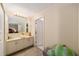Bright main bathroom with ample vanity storage and adjacent toilet and shower room at 10978 Sw 83Rd Ave, Ocala, FL 34481