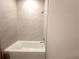 A tiled tub and shower combination inside of a clean, bright bathroom at 13374 Sw 63Rd Ter, Ocala, FL 34473