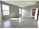Bedroom with light gray wood-look tile flooring, neutral paint, and ample natural light at 13374 Sw 63Rd Ter, Ocala, FL 34473