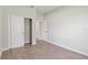 Bedroom with sliding closet doors and neutral wall color, and wood-look tile flooring at 13374 Sw 63Rd Ter, Ocala, FL 34473