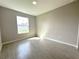 Bright bedroom with a window and light gray walls, with light wood-look flooring at 13374 Sw 63Rd Ter, Ocala, FL 34473