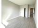 Spacious bedroom with closet and doorway, featuring light gray walls and wood look floors at 13374 Sw 63Rd Ter, Ocala, FL 34473