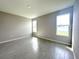 Bedroom with light gray wood-look tile flooring, neutral paint, and ample natural light at 13374 Sw 63Rd Ter, Ocala, FL 34473
