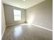 Bedroom with a window providing ample natural light and wood look floors at 13374 Sw 63Rd Ter, Ocala, FL 34473