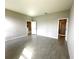 Bedroom with light gray wood-look tile flooring, neutral paint, and walk-in shower en suite at 13374 Sw 63Rd Ter, Ocala, FL 34473