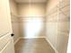 Walk-in closet with open shelving, and light wood look flooring at 13374 Sw 63Rd Ter, Ocala, FL 34473