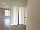 Entryway with bi-fold closet and view into living room featuring light gray wood-look tile flooring at 13374 Sw 63Rd Ter, Ocala, FL 34473