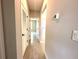 Bright hallway with wood-look tile flooring and doors leading to various rooms at 13374 Sw 63Rd Ter, Ocala, FL 34473