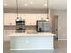 Modern kitchen with stainless steel appliances, white cabinets, and stylish pendant lighting at 13374 Sw 63Rd Ter, Ocala, FL 34473