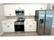 Modern kitchen with stainless steel appliances, white cabinets, and sleek countertops at 13374 Sw 63Rd Ter, Ocala, FL 34473