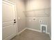 Practical laundry room with overhead shelving and tile flooring at 13374 Sw 63Rd Ter, Ocala, FL 34473