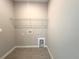 Utility room with neutral walls, tile flooring, and overhead wire shelf at 13374 Sw 63Rd Ter, Ocala, FL 34473