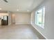 Bright living room features neutral paint, tile floors, recessed lighting, and modern stainless appliances at 13374 Sw 63Rd Ter, Ocala, FL 34473