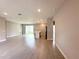 Spacious living room with tile floors, recessed lighting, and a modern island kitchen at 13374 Sw 63Rd Ter, Ocala, FL 34473