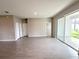 Bright living room features tile floors, neutral walls, and sliding glass doors to a patio at 13374 Sw 63Rd Ter, Ocala, FL 34473