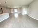 Open concept living area with tile flooring, recessed lighting and a view of the entry and kitchen at 13374 Sw 63Rd Ter, Ocala, FL 34473