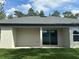 Covered patio area with sliding glass doors to the backyard, offering an outdoor living space at 13374 Sw 63Rd Ter, Ocala, FL 34473