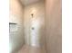 Modern walk-in shower featuring neutral tiling, a rainfall shower head, and a built-in niche at 13374 Sw 63Rd Ter, Ocala, FL 34473