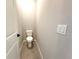 A half-bathroom featuring wood-look floors, white toilet, and a contemporary light switch at 13374 Sw 63Rd Ter, Ocala, FL 34473