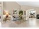 Inviting living room with neutral paint, vaulted ceiling, and tile flooring at 8257 Sw 196Th Court Rd, Dunnellon, FL 34432