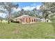 Expansive backyard featuring a screened lanai for outdoor living and entertaining at 19057 Sw 98Th Loop, Dunnellon, FL 34432