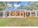 Wide view of house with screened-in porch and green back yard at 19057 Sw 98Th Loop, Dunnellon, FL 34432